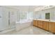 Bright bathroom featuring dual sinks, glass shower, soaking tub and natural lighting at 7935 Harrington Woods Rd, Charlotte, NC 28269