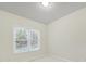 Cozy bedroom featuring neutral carpeting and a large window at 7935 Harrington Woods Rd, Charlotte, NC 28269