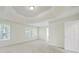 Spacious bedroom featuring large windows, trey ceiling and neutral carpeting at 7935 Harrington Woods Rd, Charlotte, NC 28269