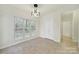 Sunny breakfast nook featuring tile flooring, a window with a view, and overhead light at 7935 Harrington Woods Rd, Charlotte, NC 28269