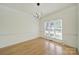 Well-lit dining room with hardwood floors and modern light fixture at 7935 Harrington Woods Rd, Charlotte, NC 28269