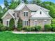 Charming two-story brick home with manicured lawn and mature trees in a desirable neighborhood at 7935 Harrington Woods Rd, Charlotte, NC 28269