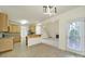 Open kitchen area with wood cabinetry, connecting to the living space with natural light at 7935 Harrington Woods Rd, Charlotte, NC 28269