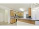Functional kitchen with wood cabinets, stainless steel appliances, and a breakfast bar overlooking the living space at 7935 Harrington Woods Rd, Charlotte, NC 28269