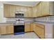Well-maintained kitchen featuring a gas range, microwave, wood cabinetry, and plenty of counter space at 7935 Harrington Woods Rd, Charlotte, NC 28269