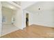Spacious open-concept room with hardwood flooring, staircase, and natural light perfect for entertaining at 7935 Harrington Woods Rd, Charlotte, NC 28269