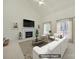 Bright living room featuring a marble fireplace, neutral furniture, and an elegant vaulted ceiling at 7935 Harrington Woods Rd, Charlotte, NC 28269
