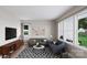 Inviting living room with gray sofa, blue loveseat, modern rug, and ample natural light at 8048 Cedarsmith Ct, Charlotte, NC 28217