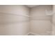 Empty walk-in closet with installed white wire shelving at 8048 Cedarsmith Ct, Charlotte, NC 28217