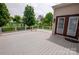 A large gray deck with white railings and brown trim overlooks the green backyard through a glass door at 8810 Cool Meadow Dr, Huntersville, NC 28078