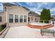 A spacious backyard deck, great for gatherings, with a tan house and black roof in the background at 8810 Cool Meadow Dr, Huntersville, NC 28078