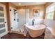 Bathroom featuring frameless glass shower and soaking tub with black fixtures, and modern vanity at 8810 Cool Meadow Dr, Huntersville, NC 28078