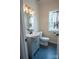 Stylish half-bathroom featuring a vanity sink, modern lighting, and tiled flooring at 8810 Cool Meadow Dr, Huntersville, NC 28078