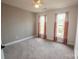 Neutral bedroom featuring carpet, a ceiling fan, and soft lighting through large windows at 8810 Cool Meadow Dr, Huntersville, NC 28078
