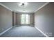 Bedroom with neutral walls, plush carpet, and ample natural light from the large windows at 8810 Cool Meadow Dr, Huntersville, NC 28078