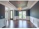 Formal dining room with dark blue walls, white trim, hardwood floors and a decorative chandelier at 8810 Cool Meadow Dr, Huntersville, NC 28078