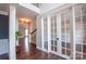 Inviting entryway with hardwood floors, white trim and french doors leading to an office space at 8810 Cool Meadow Dr, Huntersville, NC 28078