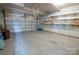 Spacious garage with shelving, painted walls, and an automatic door ready for any project at 8810 Cool Meadow Dr, Huntersville, NC 28078