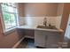 Convenient laundry room area with a utility sink, white subway tile backsplash, and storage at 8810 Cool Meadow Dr, Huntersville, NC 28078
