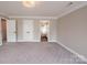 Spacious main bedroom with neutral walls, carpet, white trim, and open doorway to the main bath at 8810 Cool Meadow Dr, Huntersville, NC 28078
