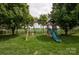 Backyard playground with slide, swings, and grassy area great for , surrounded by shady trees at 8810 Cool Meadow Dr, Huntersville, NC 28078