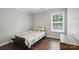This bedroom has wood floors, large window, and is styled with yellow and navy colors at 9312 Seamill Rd, Charlotte, NC 28278