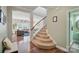 Welcoming entryway featuring hardwood floors, staircase, and views into the living room at 9312 Seamill Rd, Charlotte, NC 28278