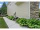 Home exterior featuring lush landscaping along the foundation and stone details at 9312 Seamill Rd, Charlotte, NC 28278