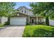 Charming two-story home featuring a stone facade, covered porch, and well-manicured lawn at 9312 Seamill Rd, Charlotte, NC 28278