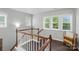 Hallway featuring three windows with views of outside and rich hard wood floors at 9312 Seamill Rd, Charlotte, NC 28278