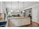 Open concept kitchen with island, hardwood floors, eat-in breakfast area, and open access to the living room at 9312 Seamill Rd, Charlotte, NC 28278