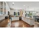 Bright kitchen featuring white cabinets, stainless appliances, hardwood floors, and a large kitchen island at 9312 Seamill Rd, Charlotte, NC 28278