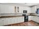 Bright kitchen featuring white cabinets, stainless appliances, hardwood floors, and modern countertops at 9312 Seamill Rd, Charlotte, NC 28278
