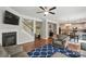 Open-concept living room with hardwood floors, a fireplace, and modern staircase at 9312 Seamill Rd, Charlotte, NC 28278
