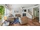 Cozy living room featuring wood floors, a fireplace, and staircase at 9312 Seamill Rd, Charlotte, NC 28278