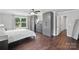 Main bedroom boasts hardwood floors, bright windows and gray and wardrobes with built-in dresser at 9312 Seamill Rd, Charlotte, NC 28278