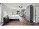 Main bedroom boasts wood floors, two windows, ceiling fan and grey and dressers and wardrobe at 9312 Seamill Rd, Charlotte, NC 28278