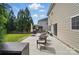 Enjoy outdoor living on the spacious patio with furniture, grill and a well-manicured backyard at 9312 Seamill Rd, Charlotte, NC 28278