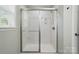 This bathroom showcases a bright standing shower with sliding glass doors at 9312 Seamill Rd, Charlotte, NC 28278