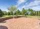 Backyard brick patio with a stone seat wall and well maintained landscape at 9636 Cotton Stand Rd, Charlotte, NC 28277