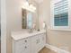 Well-lit bathroom with a white vanity, modern mirror, and tile flooring at 9636 Cotton Stand Rd, Charlotte, NC 28277