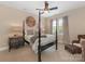This bedroom boasts a four poster bed, ceiling fan, and natural light from the window at 9636 Cotton Stand Rd, Charlotte, NC 28277