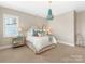 Bedroom featuring a whimsical chandelier, neutral paint, and a quaint seating area at 9636 Cotton Stand Rd, Charlotte, NC 28277