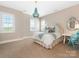Charming bedroom with white furniture, blue chandelier, and ample sunlight at 9636 Cotton Stand Rd, Charlotte, NC 28277