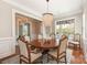 Elegant dining room with a chandelier, seating for six, and hardwood floors at 9636 Cotton Stand Rd, Charlotte, NC 28277