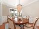 Dining room featuring a round wooden table, chandelier, and stylish chairs at 9636 Cotton Stand Rd, Charlotte, NC 28277