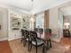 Elegant dining room featuring a wooden table, stylish chairs, built-in shelving, and window shutters at 9636 Cotton Stand Rd, Charlotte, NC 28277