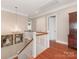 Hallway with hardwood flooring, a white decorative chandelier and staircase at 9636 Cotton Stand Rd, Charlotte, NC 28277