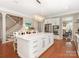 Bright kitchen featuring a large island with white cabinetry and quartz countertops, complemented by stainless steel appliances at 9636 Cotton Stand Rd, Charlotte, NC 28277