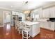 Bright kitchen with white cabinetry, stainless steel appliances, and a large island with seating at 9636 Cotton Stand Rd, Charlotte, NC 28277